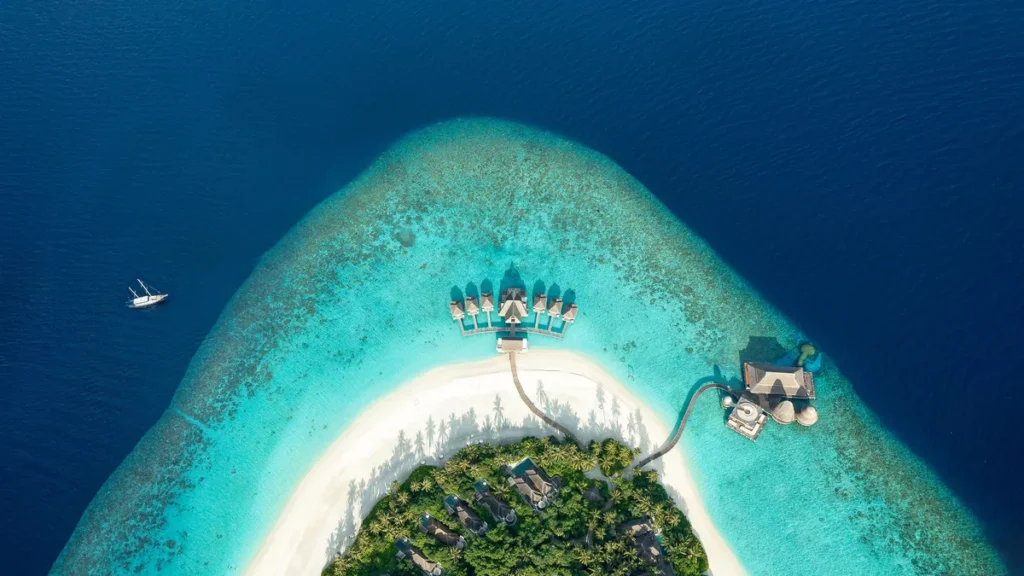 Aerial view of a Maldives resort island and its lagoon