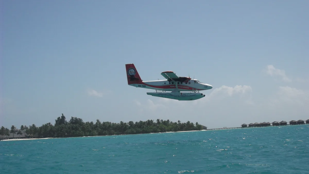 Seaplane landing on a lagoon in the Maldives