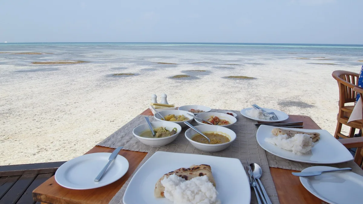 Table laid for a meal on a beach in the Maldives