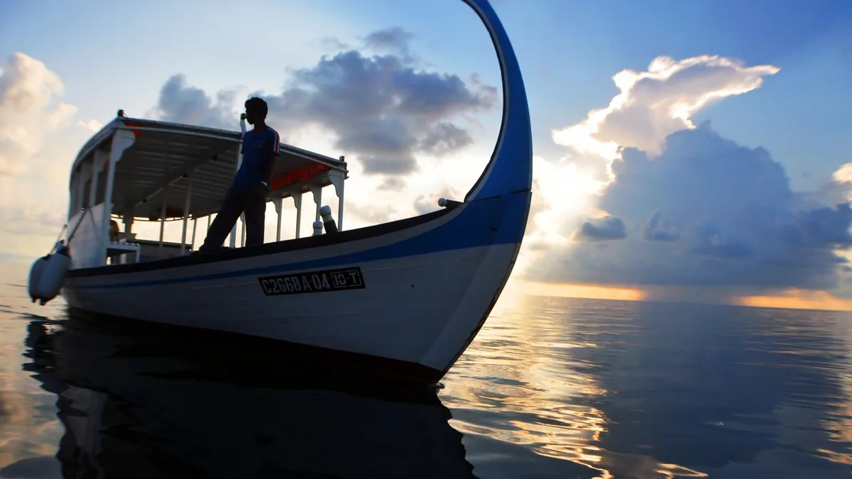 Traditional dhoni boat at sunset in the Maldives